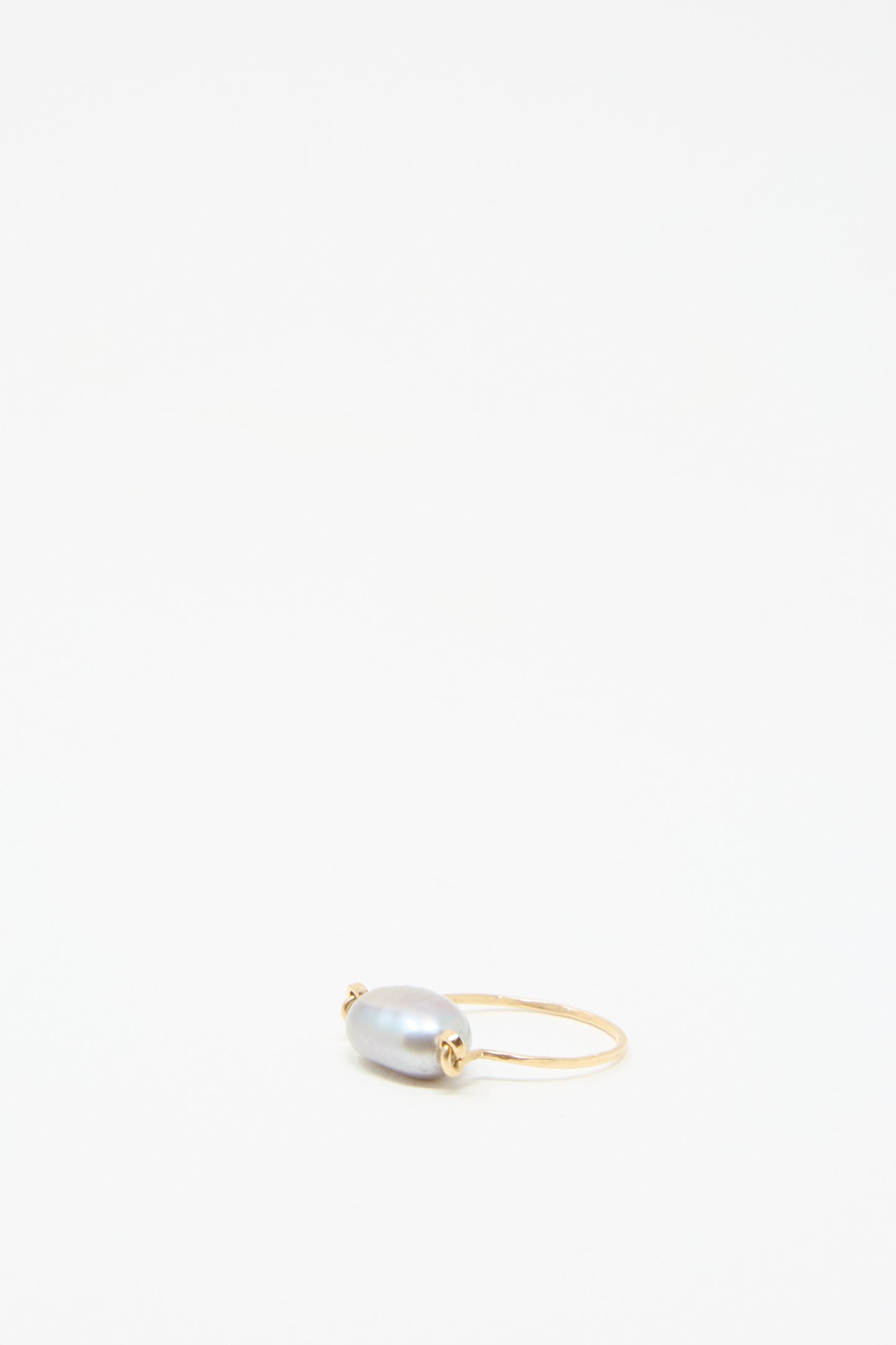 The Baroque Pearl Ring in Silver by Mary MacGill, featuring a gray baroque pearl, is  displayed on a plain white background.