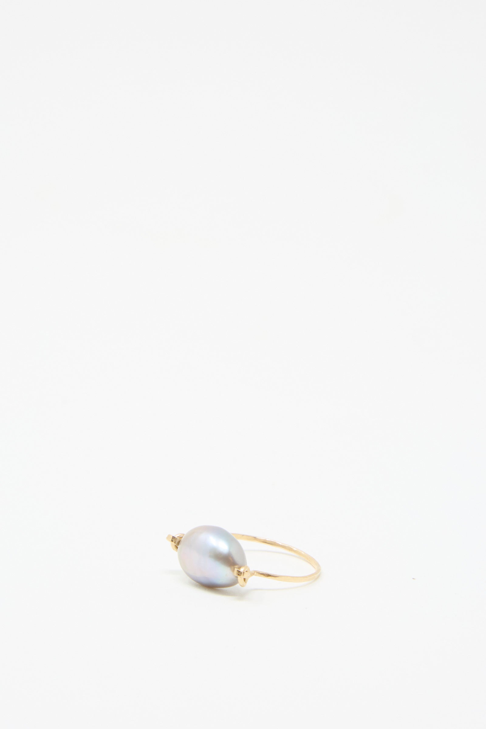 Introducing the Baroque Pearl Ring in Silver by Mary MacGill, a handcrafted masterpiece showcasing a captivating Silver Baroque pearl as its centerpiece, elegantly framed against a plain white background. 