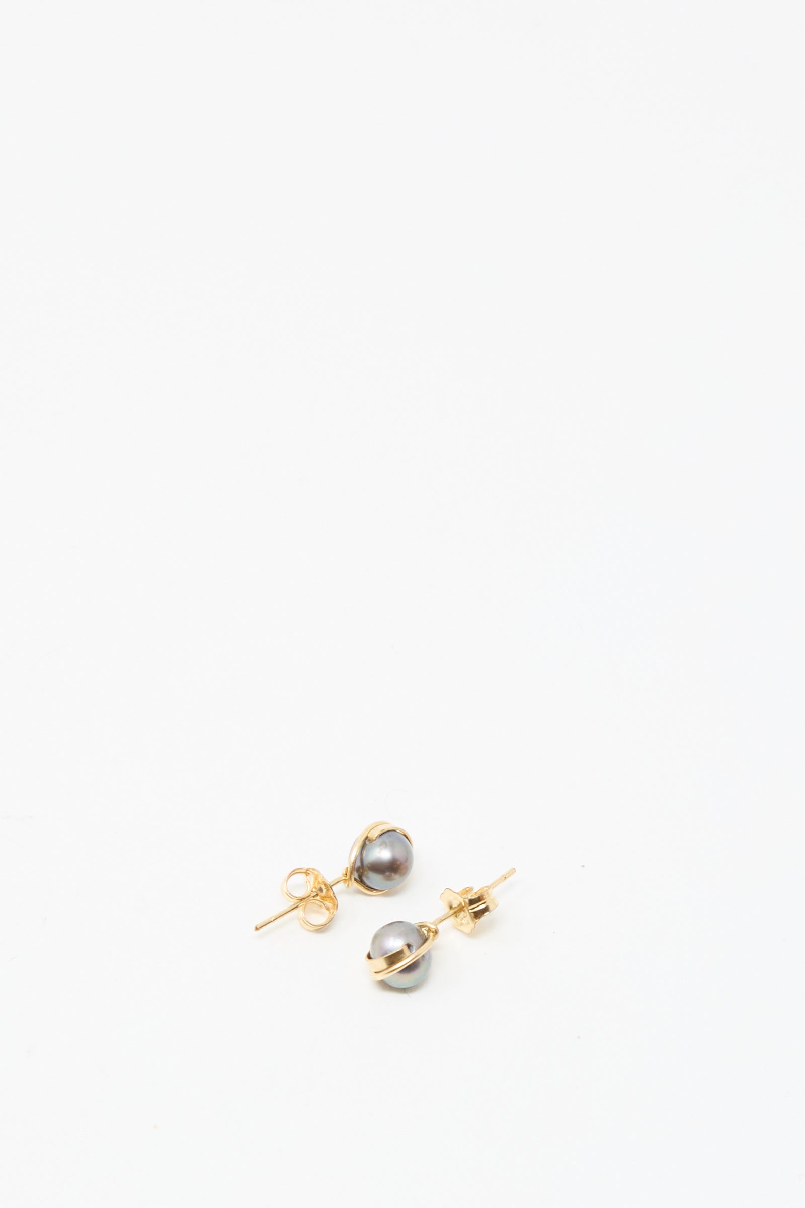 The Mary MacGill Baroque Pearl Studs in Charcoal feature round gray pearls on gold-filled posts, displayed against a plain white background—ideal for lovers of classic handmade earrings.