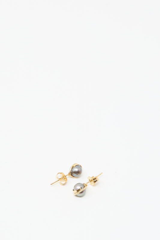 The Mary MacGill Baroque Pearl Studs in Charcoal feature round gray pearls on gold-filled posts, displayed against a plain white background—ideal for lovers of classic handmade earrings.