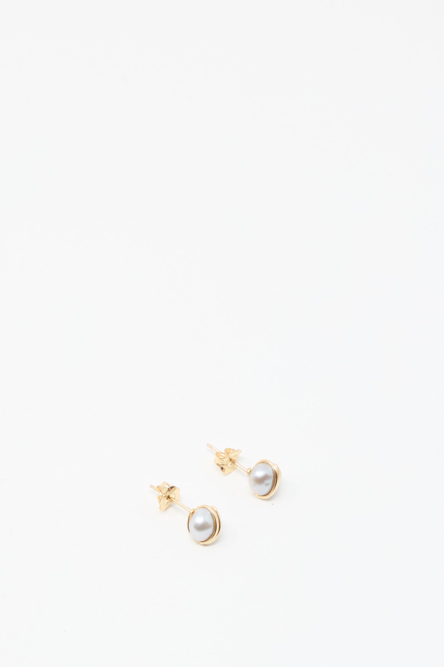 A pair of Mary MacGill Baroque Pearl Studs in Silver featuring round white pearls, displayed on a white background.