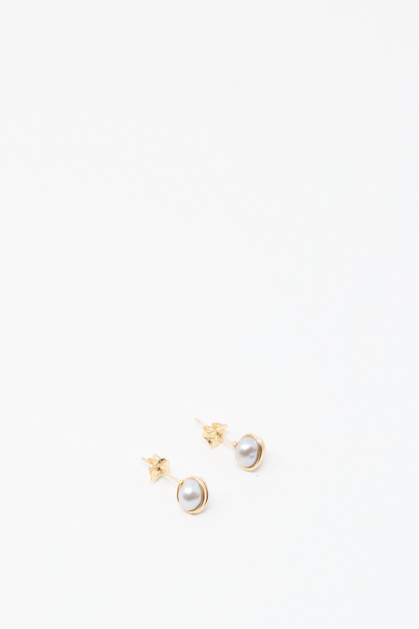 A pair of Mary MacGill Baroque Pearl Studs in Silver featuring round white pearls, displayed on a white background.