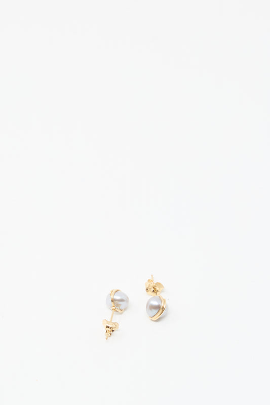 The Baroque Pearl Studs in Silver by Mary MacGill are small silver stud earrings featuring unique baroque pearls, displayed on a plain white background.