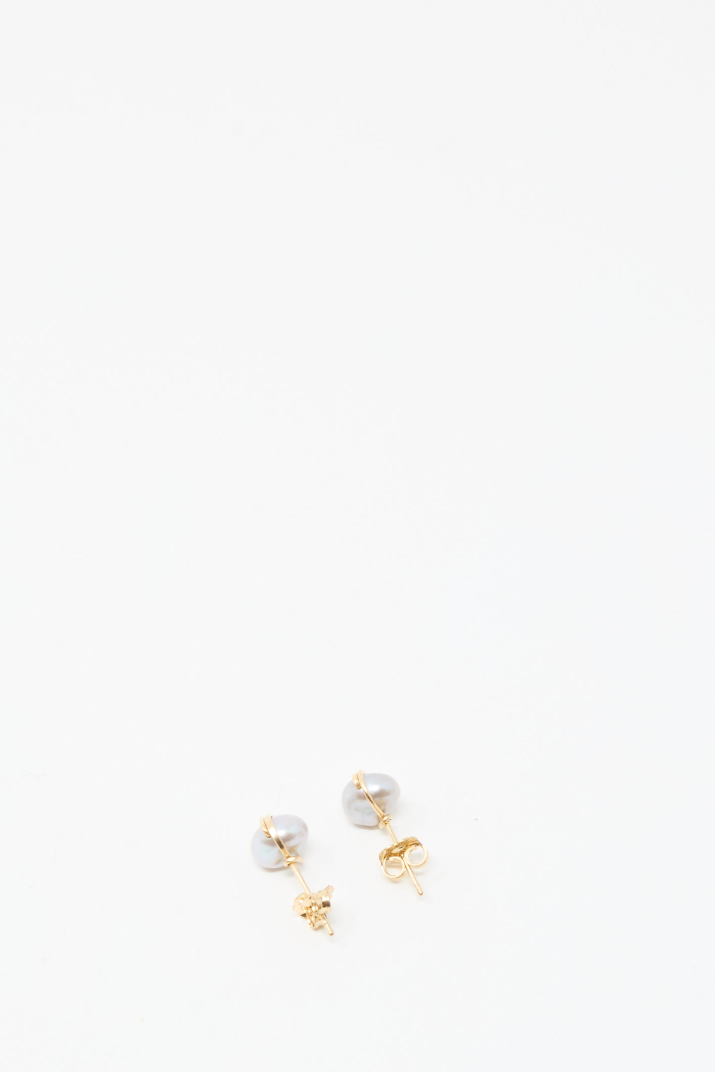 The Baroque Pearl Studs in Silver by Mary MacGill are displayed against a plain white background.