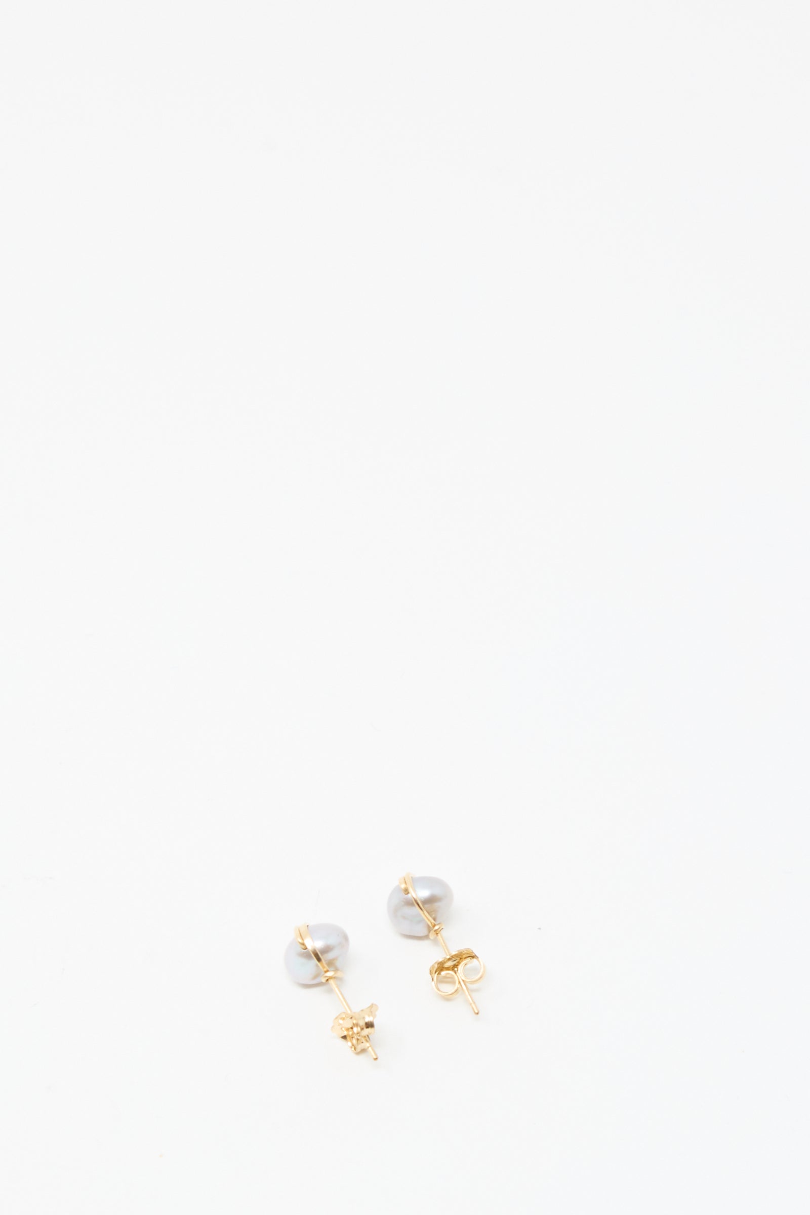 The Baroque Pearl Studs in Silver by Mary MacGill are displayed against a plain white background.
