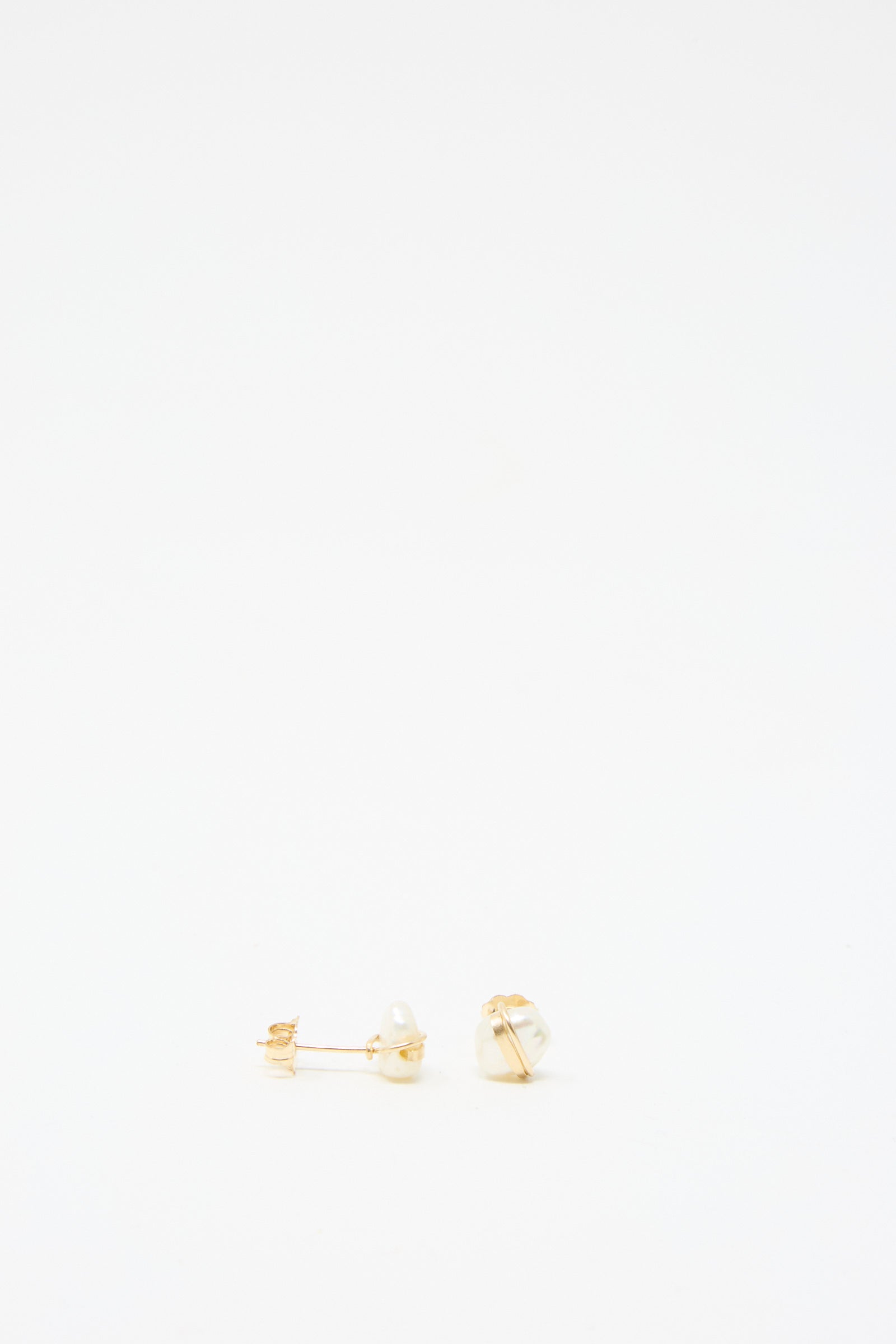 Baroque Pearl Studs in White by Mary MacGill, showcasing two baroque pearls on gold-filled posts, elegantly displayed against a plain white background.