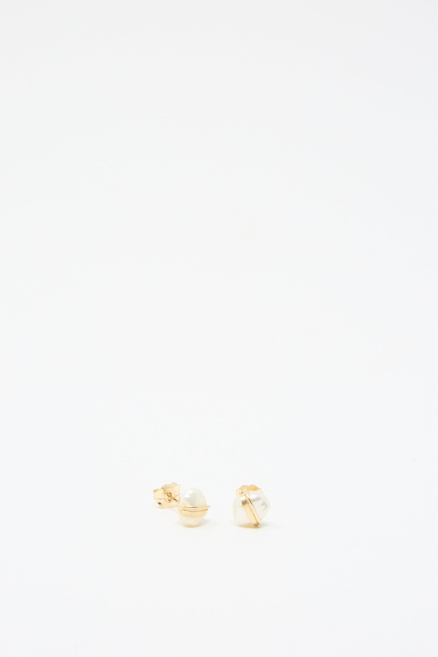 Baroque Pearl Studs in White by Mary MacGill, featuring small pearls set in gold-filled settings, exquisitely handmade and displayed against a plain white background.