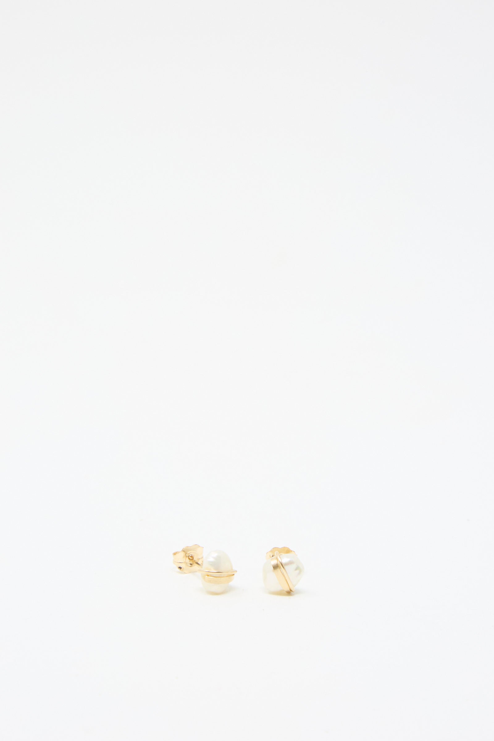 Baroque Pearl Studs in White by Mary MacGill, featuring small pearls set in gold-filled settings, exquisitely handmade and displayed against a plain white background.