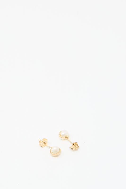 The Baroque Pearl Studs in White by Mary MacGill feature small gold-filled studs with white pearls, elegantly displayed on a plain white background.
