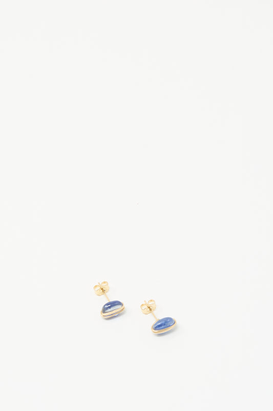 Mary MacGill Kyanite Studs earrings featuring oval blue stones wrapped in gold wire, shown on a white background.