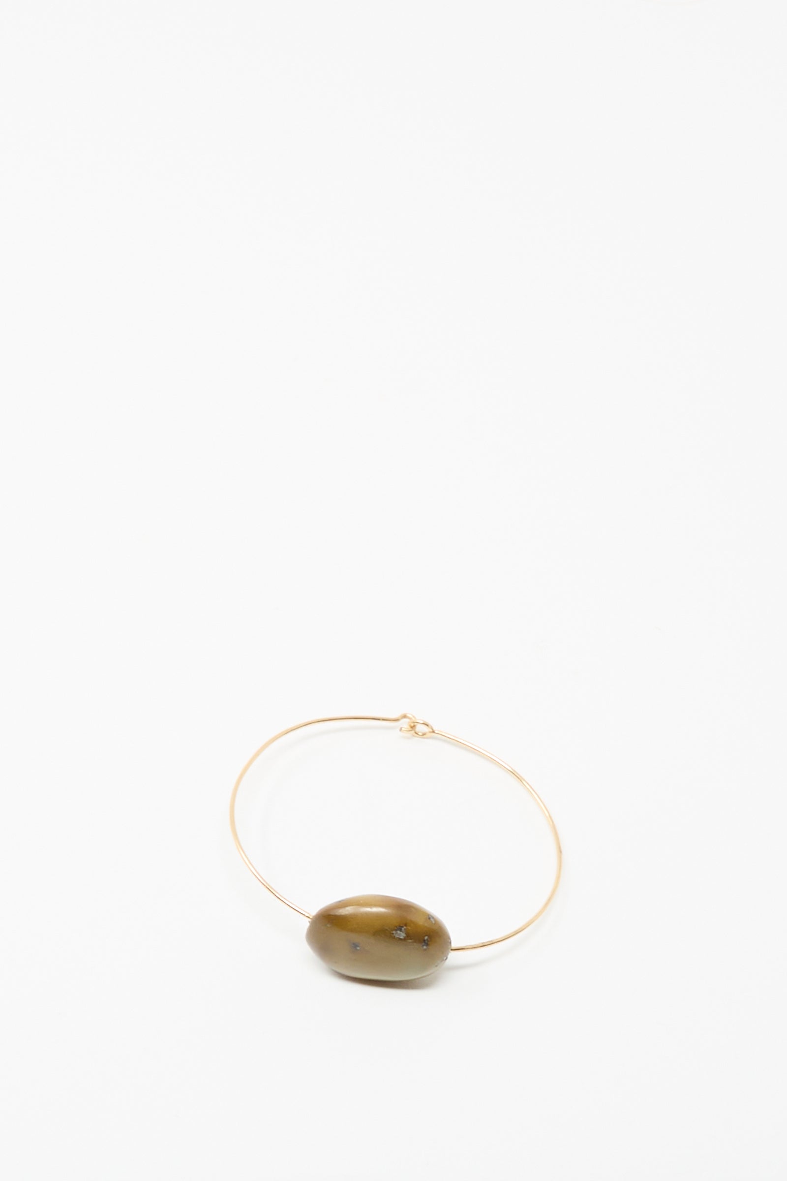 The Mary MacGill Stone Cuff Bracelet features a thin gold-filled wire and a single oval brown turquoise stone, showcased on a plain white background.