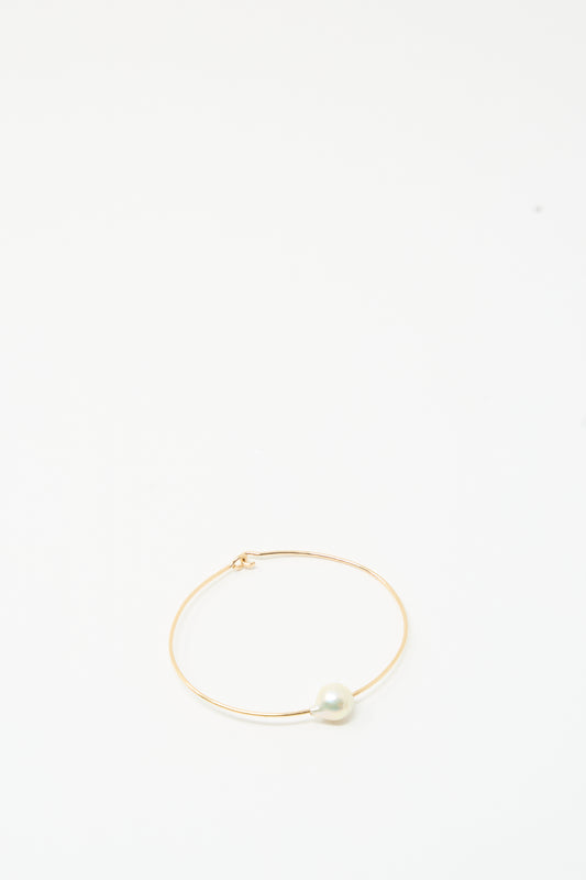 The Mary MacGill Petite Baroque Pearl Cuff in White features a thin gold-filled cuff with a single round pearl on a plain white background.