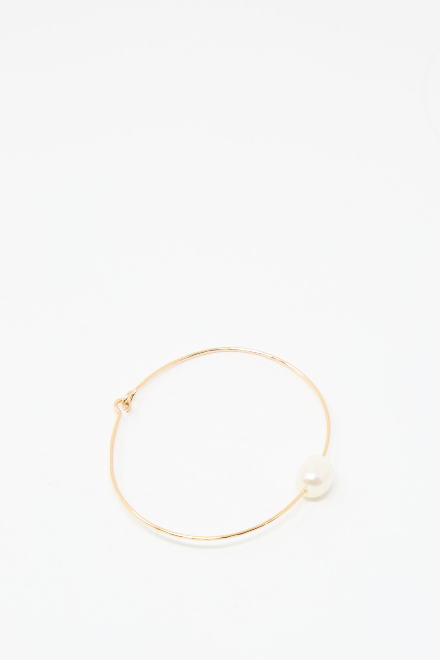 The Mary MacGill Petite Baroque Pearl Cuff in White is a timeless, handmade gold-filled bracelet featuring a single white pearl—perfect for any occasion and shown on a plain white background.