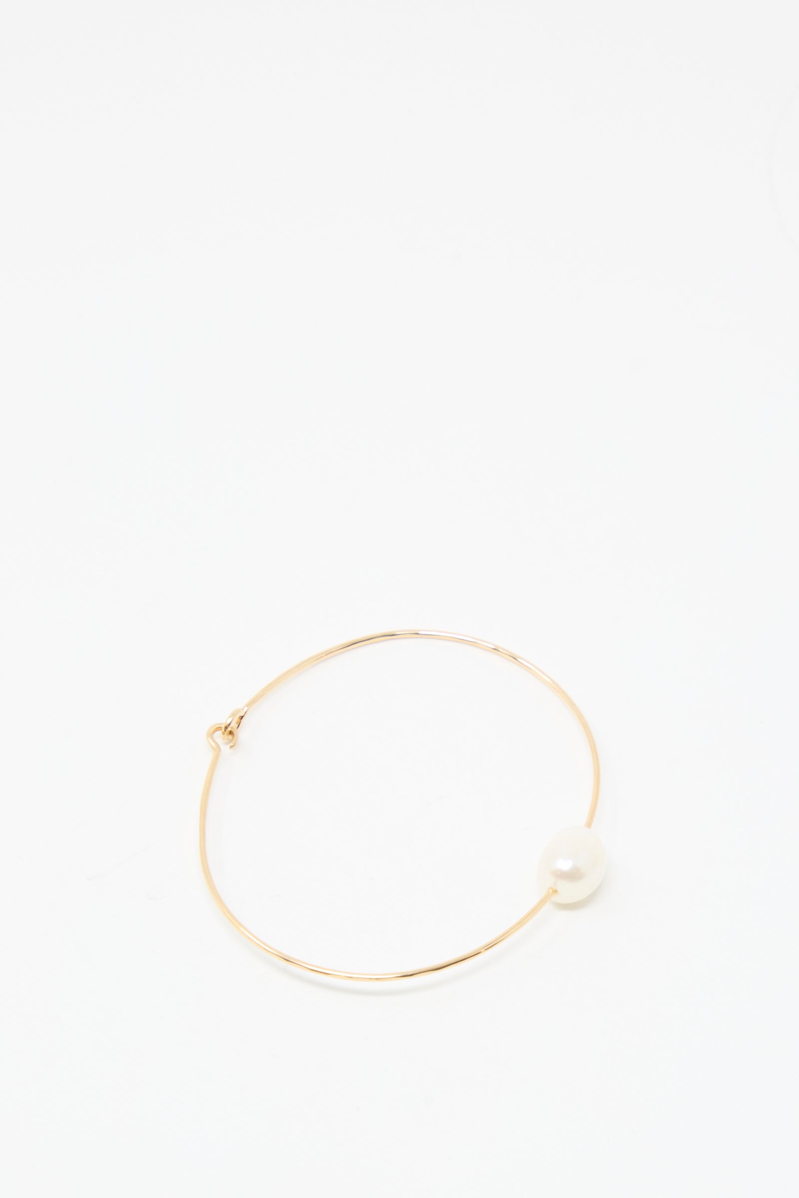 The Mary MacGill Petite Baroque Pearl Cuff in White is a timeless, handmade gold-filled bracelet featuring a single white pearl—perfect for any occasion and shown on a plain white background.