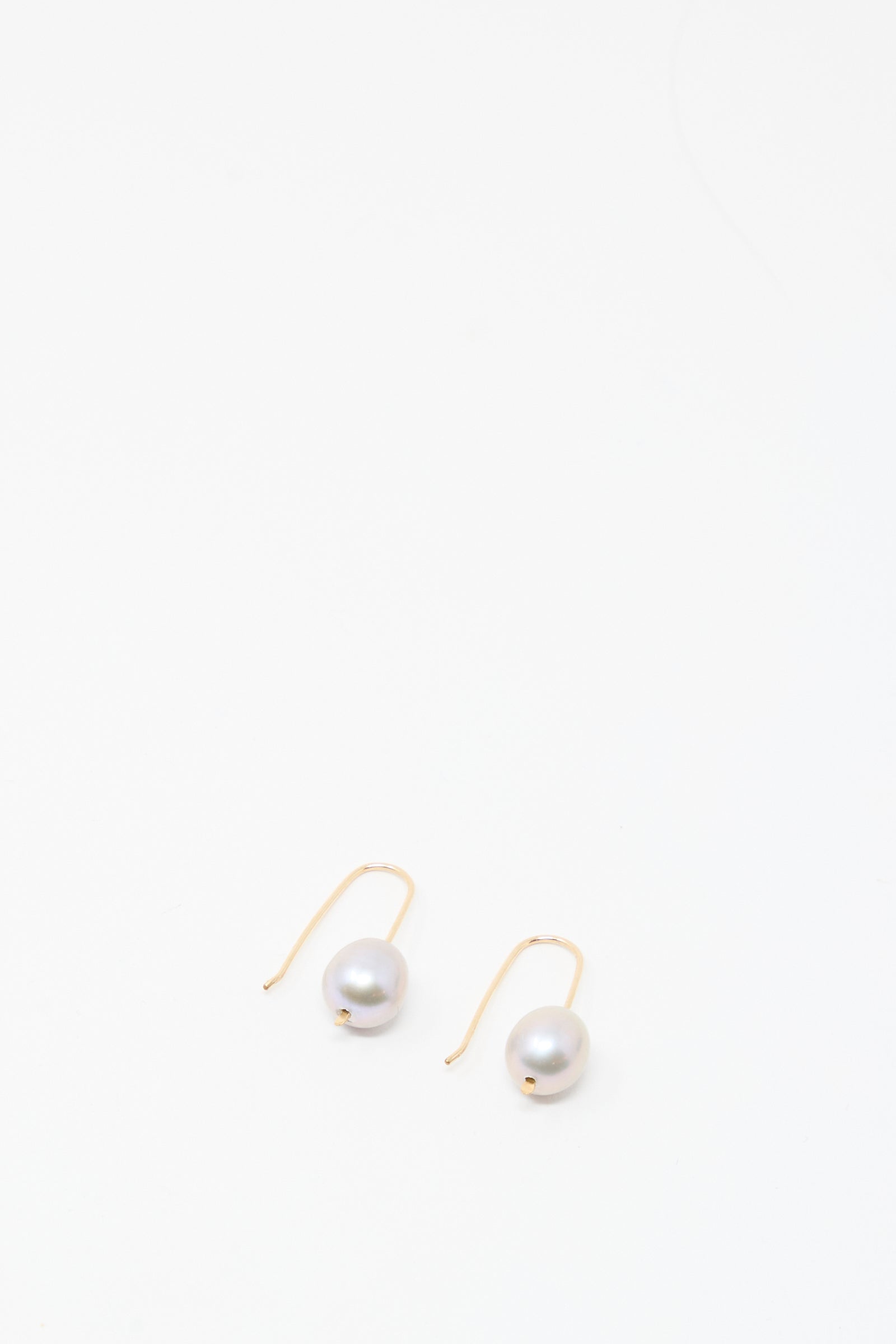 Mary MacGill Petite Baroque Pearl Drop Earrings in Silver, featuring a single round baroque pearl on silver-filled hooks, handmade in the Hudson Valley and displayed against a plain white background.