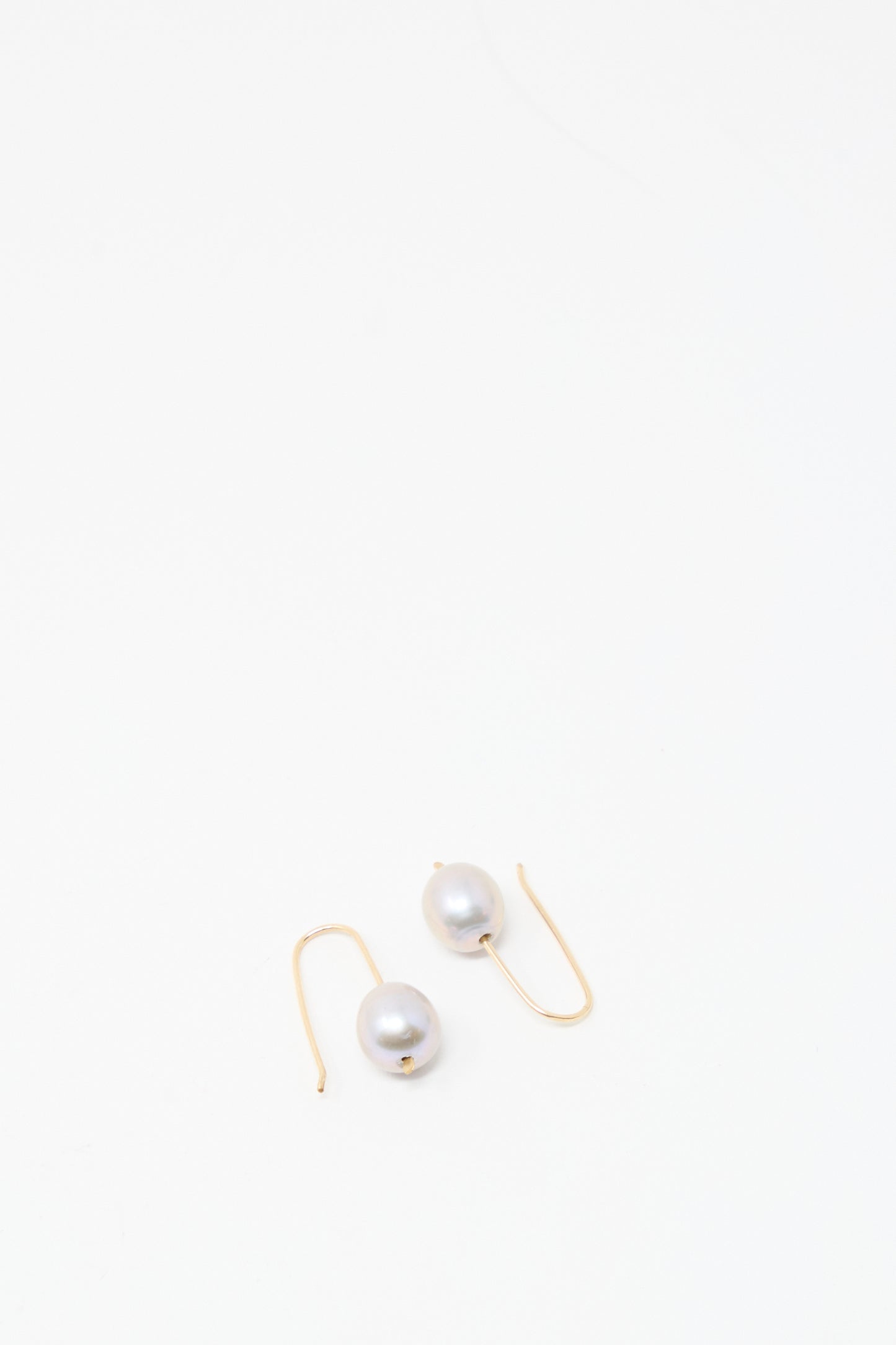Petite Baroque Pearl Drop Earrings in Silver by Mary MacGill with silver earring wire, shown on a plain white background.