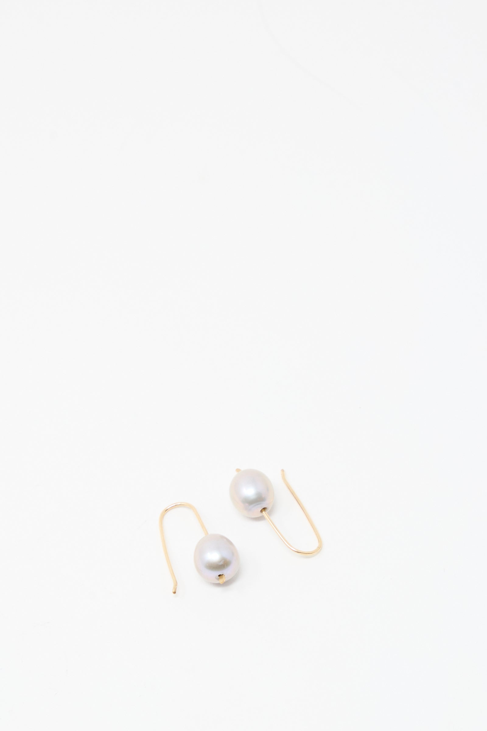 Petite Baroque Pearl Drop Earrings in Silver by Mary MacGill with silver earring wire, shown on a plain white background.