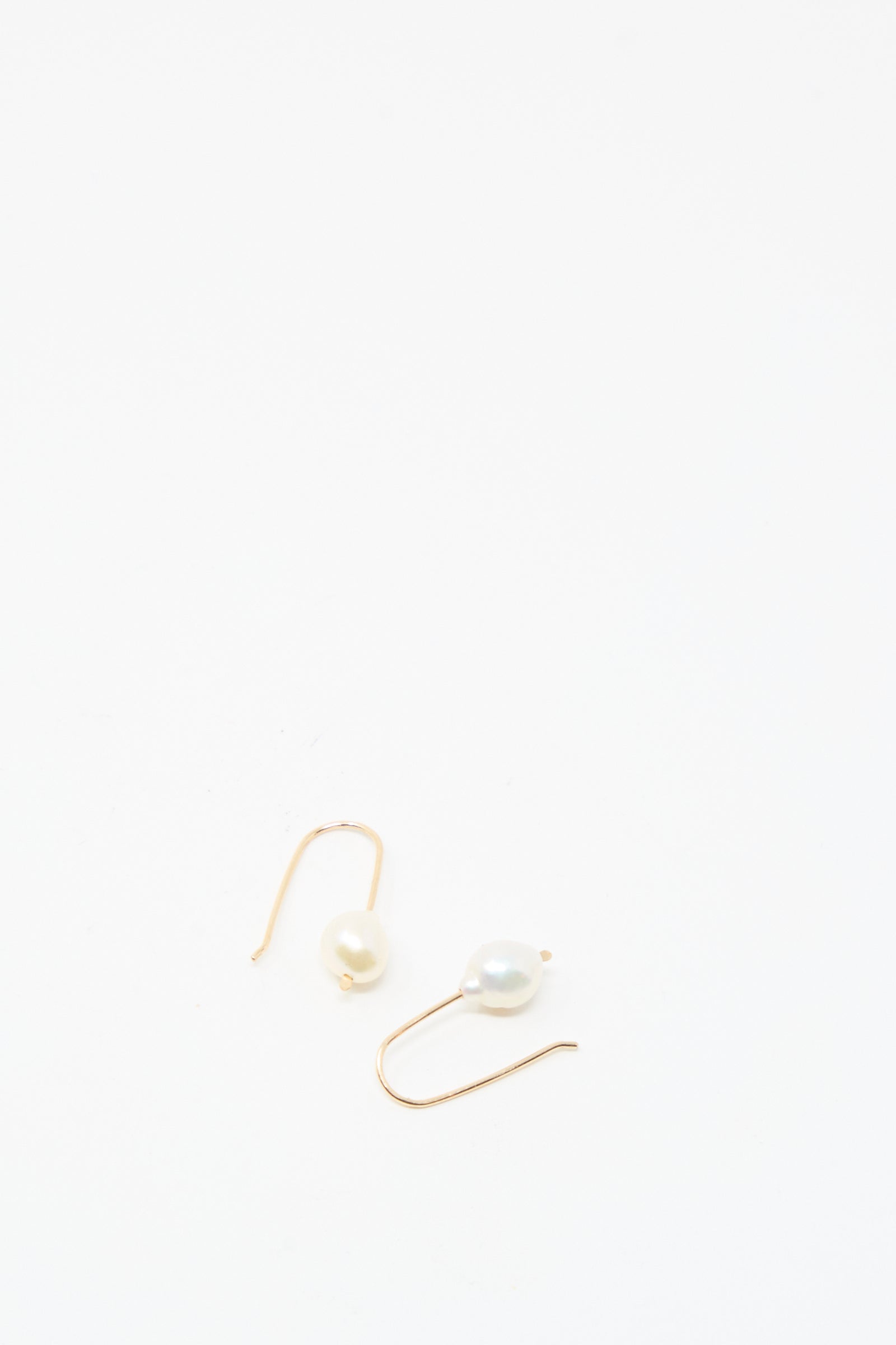 The Petite Baroque Pearl Drop Earrings in White by Mary MacGill are displayed on a plain white background, highlighting the elegance of their gold-filled design and distinctive baroque pearls.