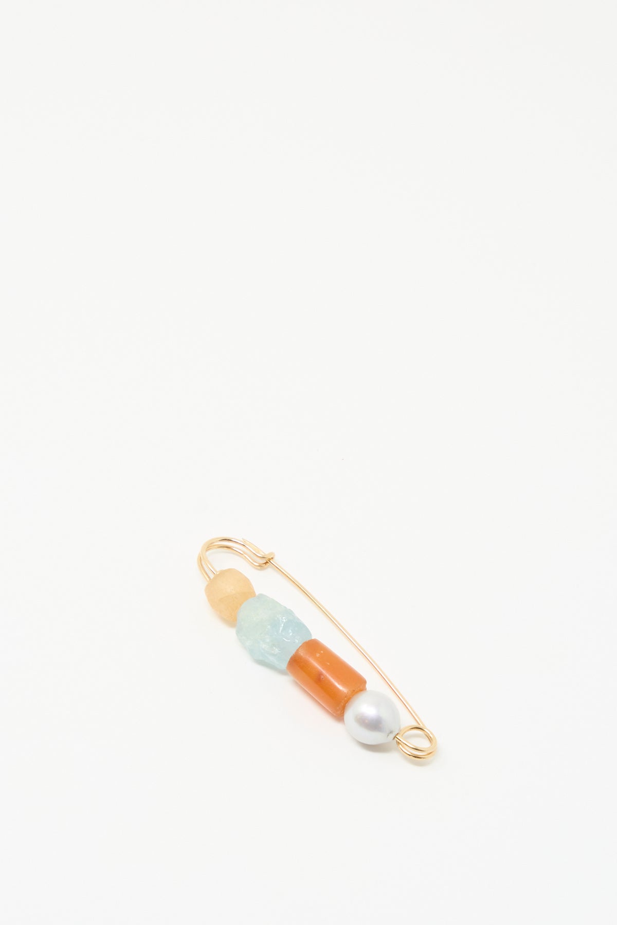 The Rising Summer Pin by Mary MacGill features four beads, including carnelian and a baroque pearl, offering handmade charm against a white background.