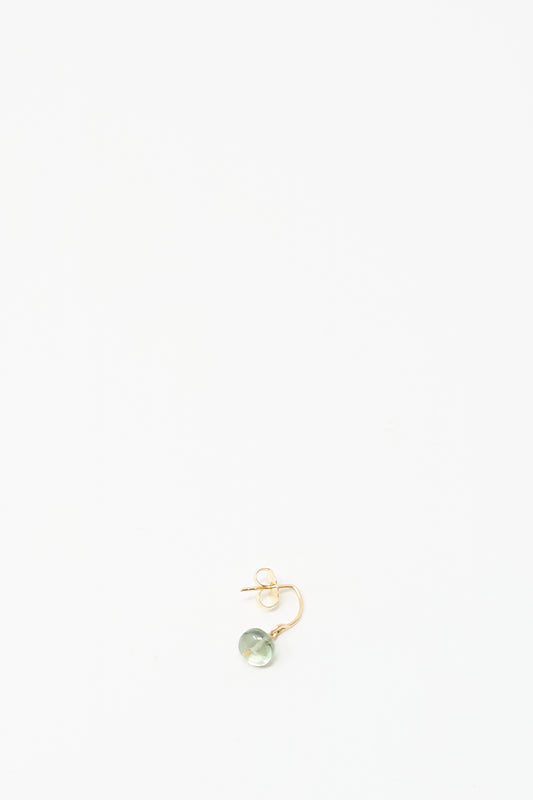 The Mary MacGill 14K Crescent Charm Earring features a round pale tourmaline and rests on a plain white background.