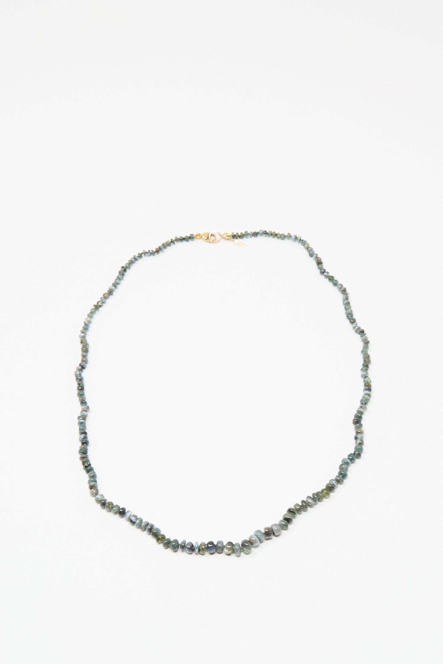 The Mary MacGill 14K Stone Layering Necklace in Cat's Eye features small, irregular green stones and a 14k gold clasp, shown on a white background.