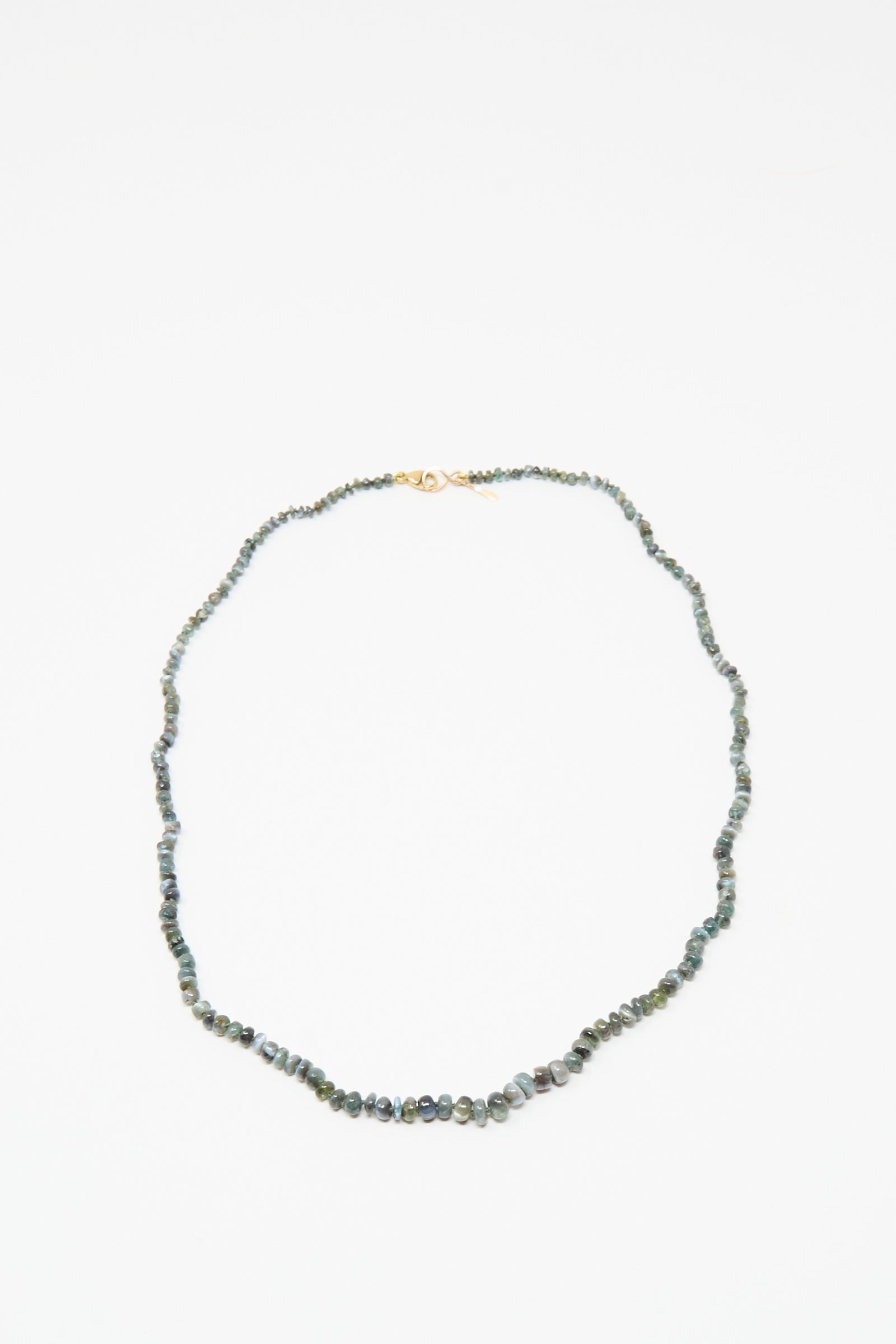 The Mary MacGill 14K Stone Layering Necklace in Cat's Eye features small, irregular green stones and a 14k gold clasp, shown on a white background.