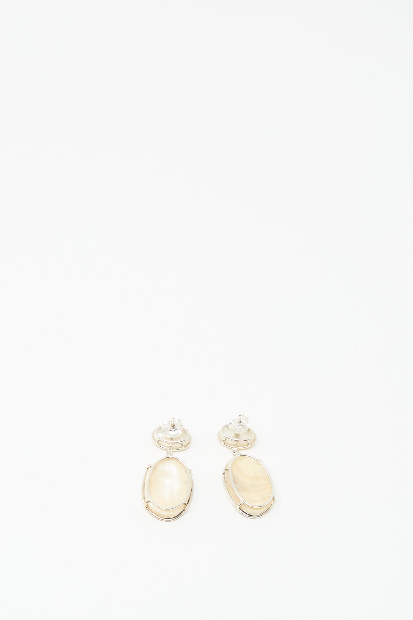 The Double Stone Drop Earrings in Moonstone and Cowrie Shell by Mary MacGill, reminiscent of cowrie shell earrings, are displayed on a plain white background.
