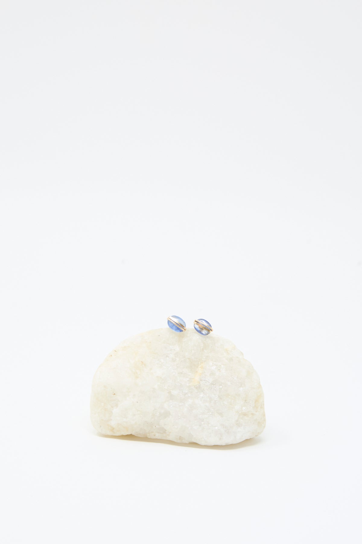 Mary MacGill Kyanite Studs, handmade with blue accents, are shown on a light stone against a plain white background.