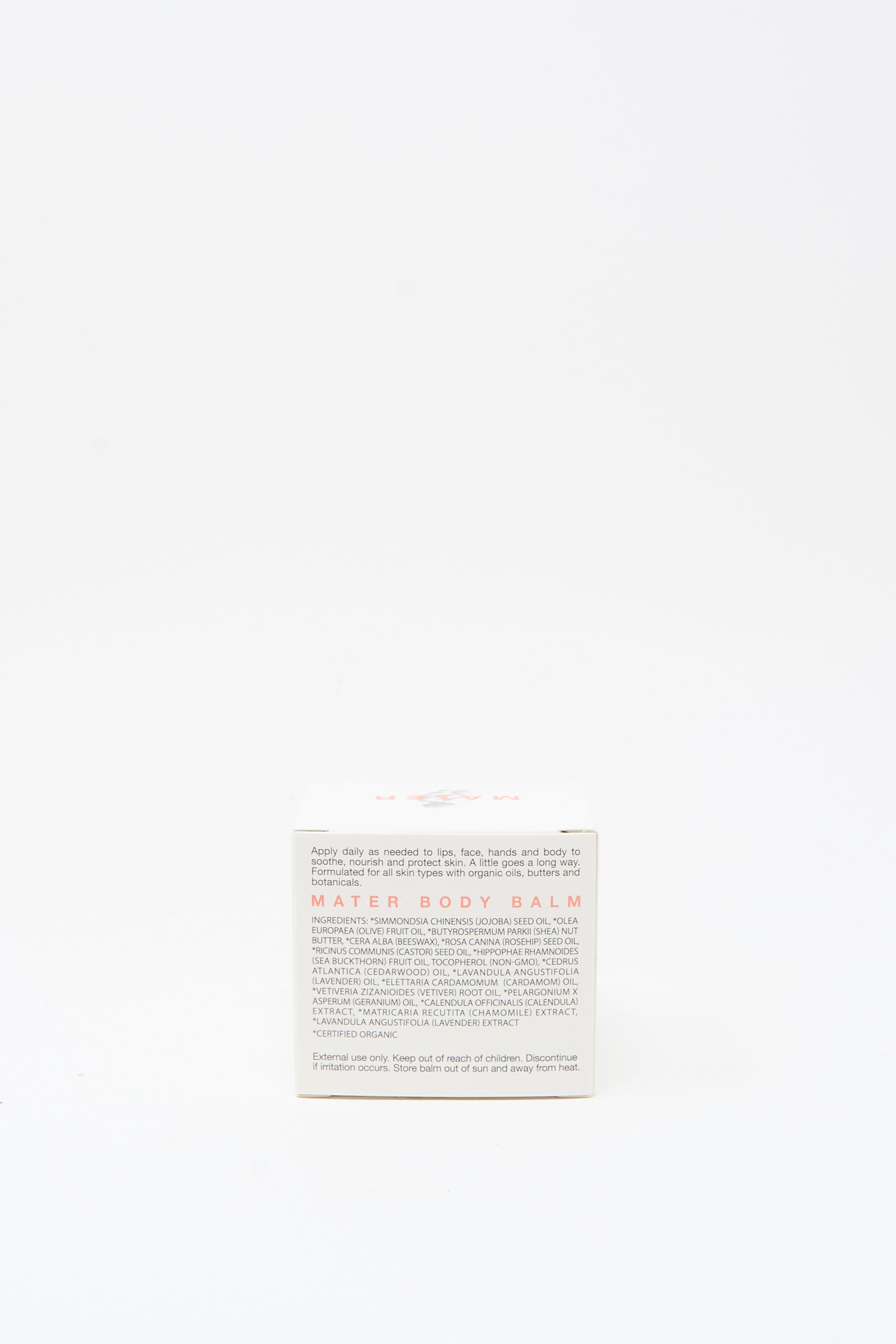 A small white box labeled "Mater Soap Cardamom and Cedarwood Body Balm 3oz" with usage instructions and details on the front, featuring a cardamom and cedarwood balm formula, set against a plain white background.