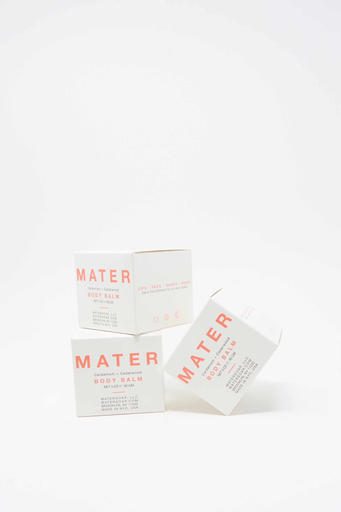 Three white Mater Soap Cardamom and Cedarwood Body Balm 3oz boxes with pink text are stacked against a plain white background, highlighting this botanical skincare essential.
