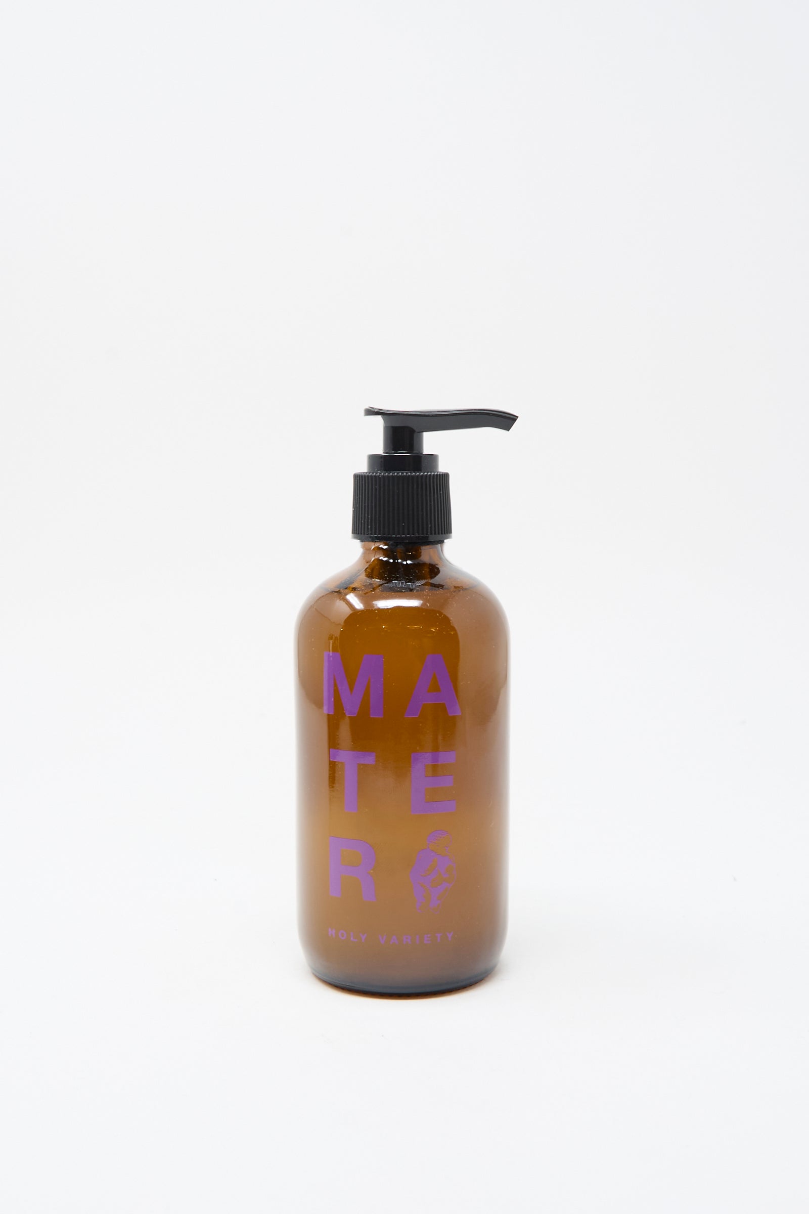 A brown glass pump bottle labeled "Mater Soap" and "Hand and Body Holy Soap" in purple text sits against a plain white background, featuring an organic hand and body soap.