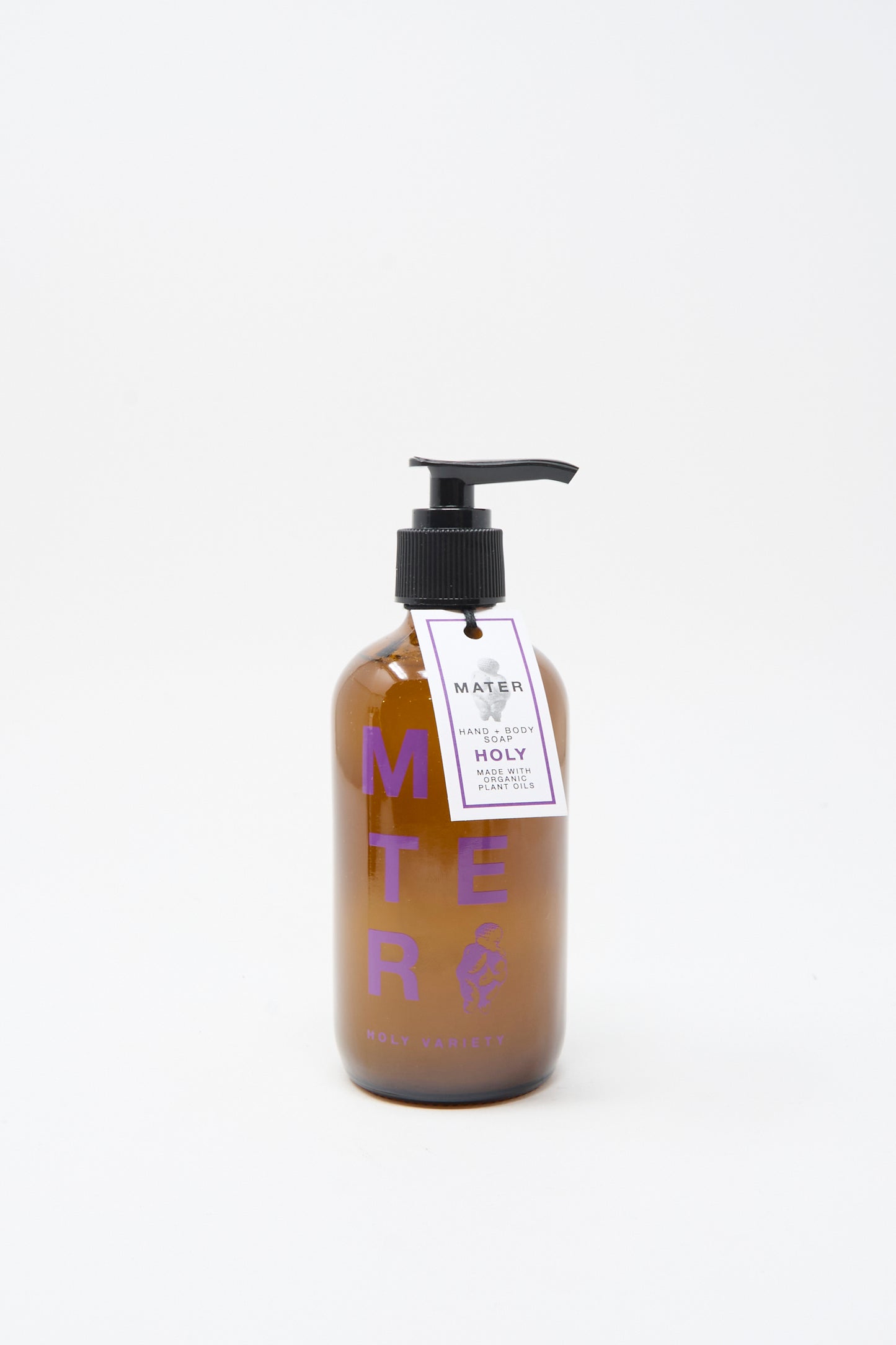 A brown pump bottle labeled "Mater Soap Hand and Body Holy Soap," with a purple and white tag, offers an elegant, plant-based soap set against a plain white background.
