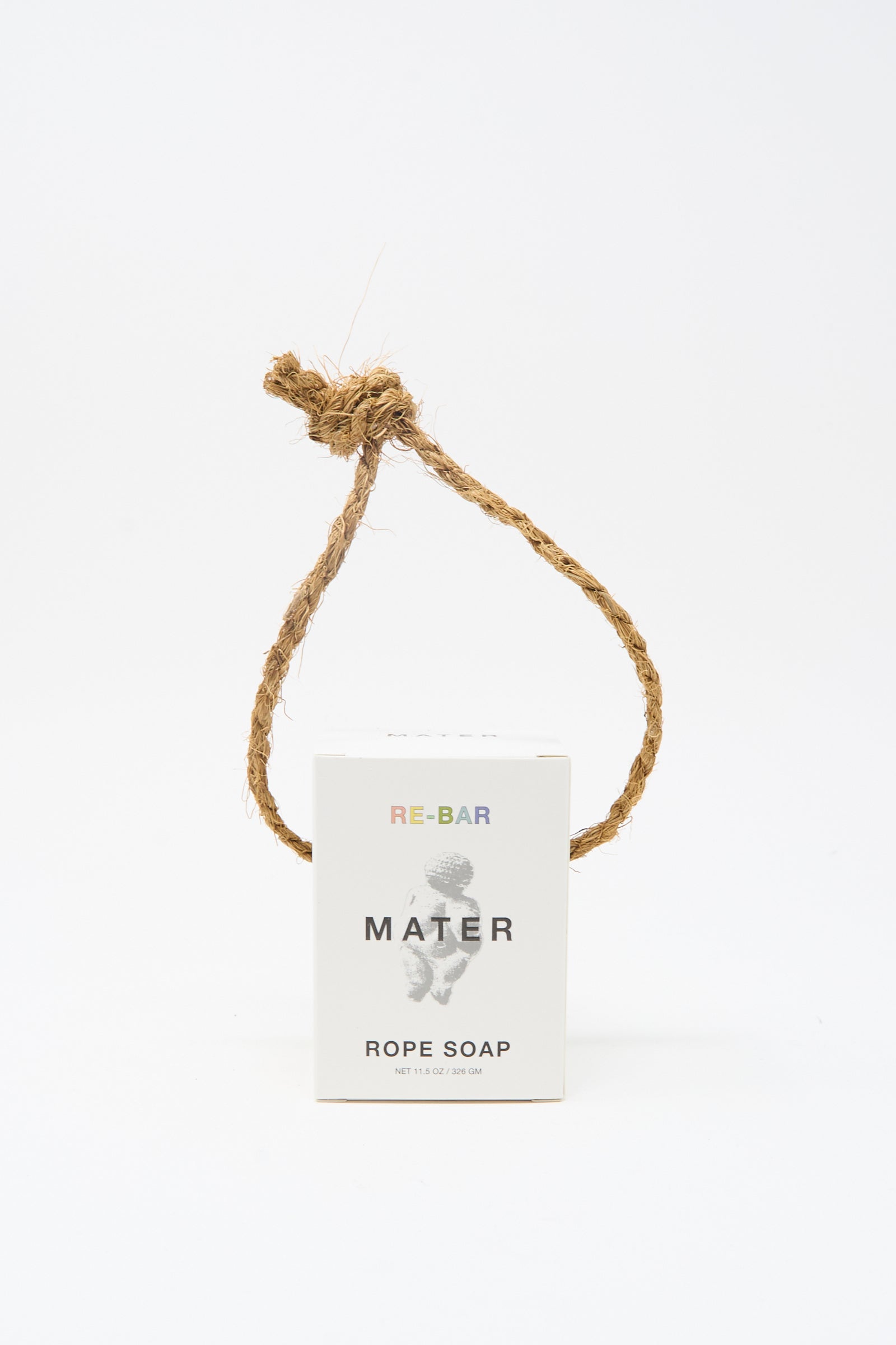 A box labeled "Re-Bar Rope Soap" by Mater Soap, featuring a thick natural rope knotted above it, stands out against a plain white background, showcasing this distinctive olive-based soap.