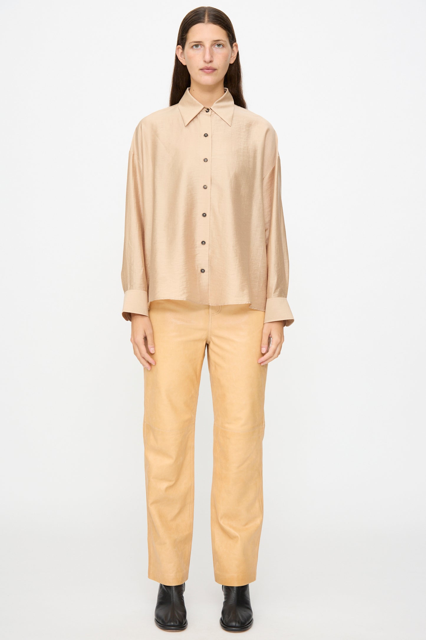 A person stands facing forward wearing the Milena Silvano Leather 5 Pocket Trousers in Bare against a plain white background.