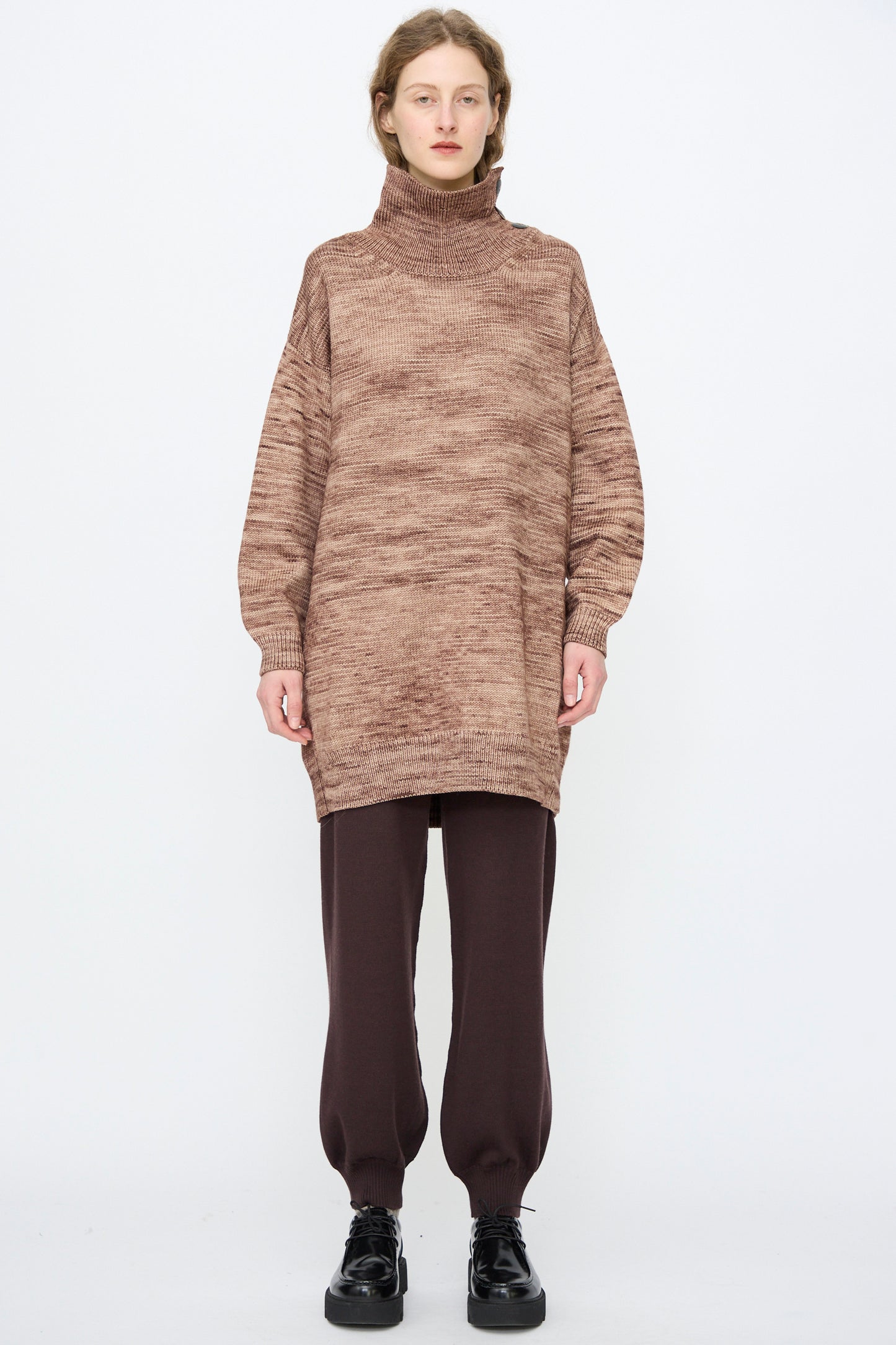Person standing against a plain background wearing the Hutton Dress in Affogato by Misha & Puff.