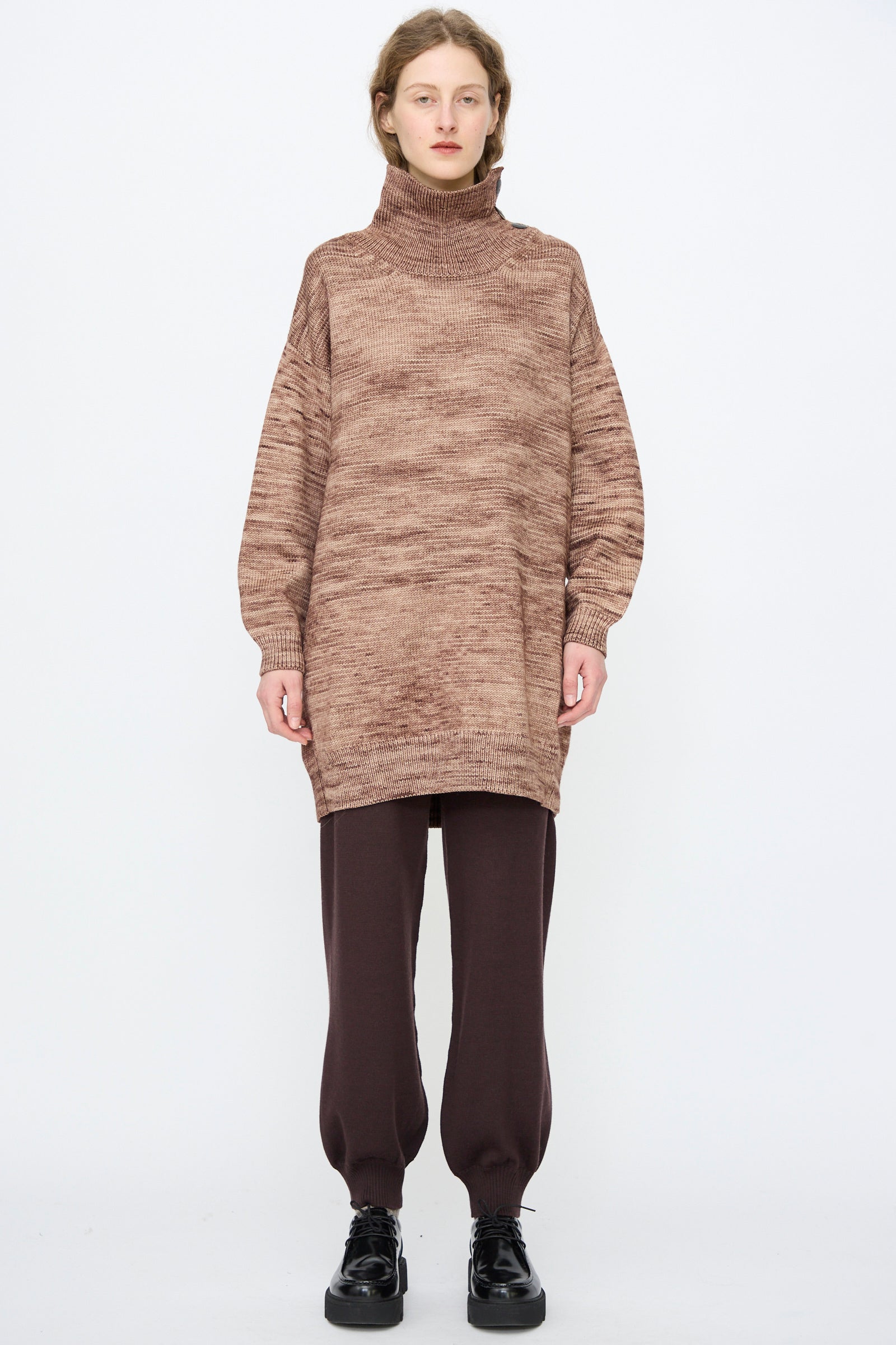 Person standing against a plain background wearing the Hutton Dress in Affogato by Misha & Puff.