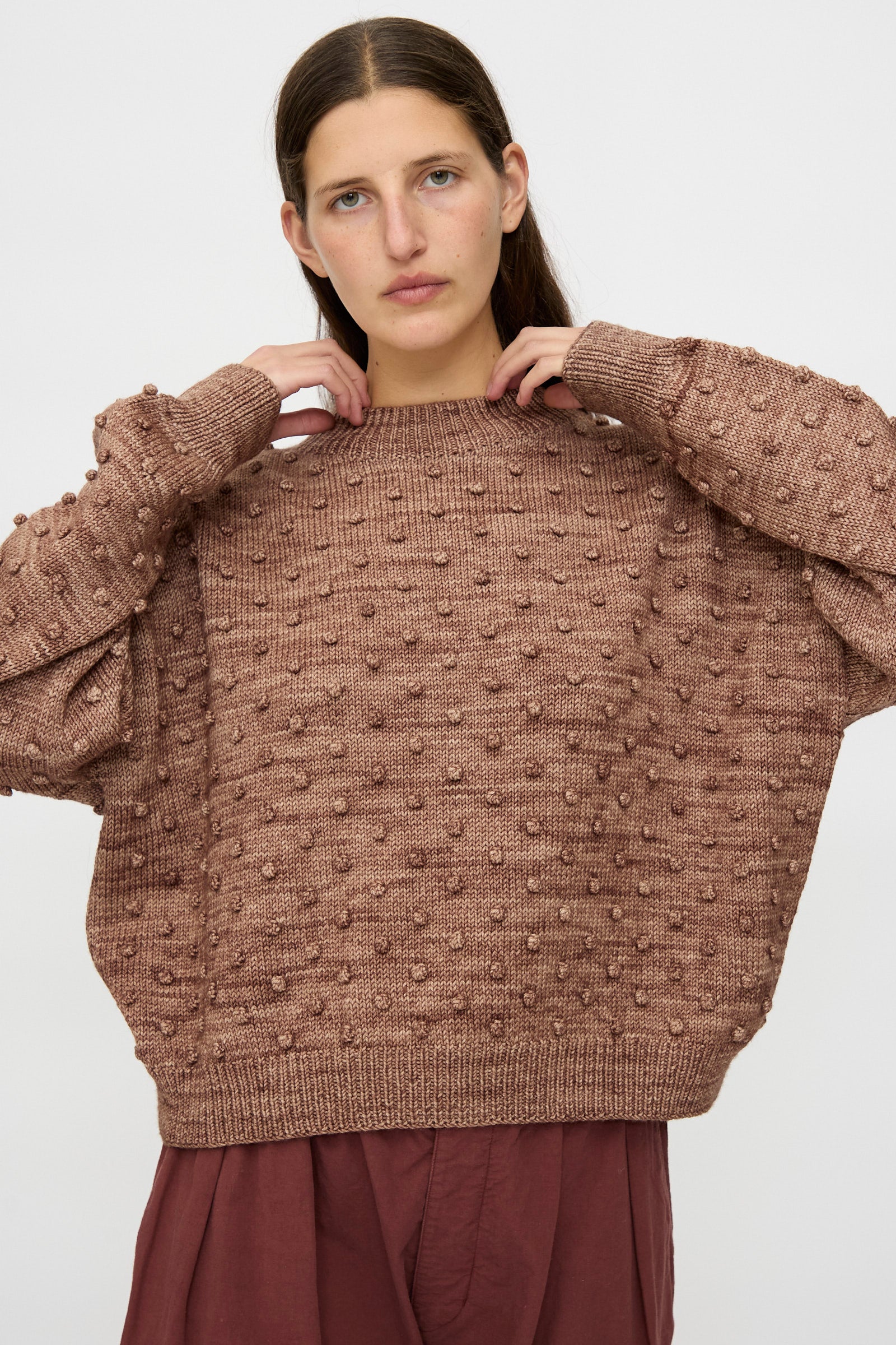 Someone wears the Misha & Puff Original Popcorn Sweater in Affogato with a matching skirt, standing against a plain light background.