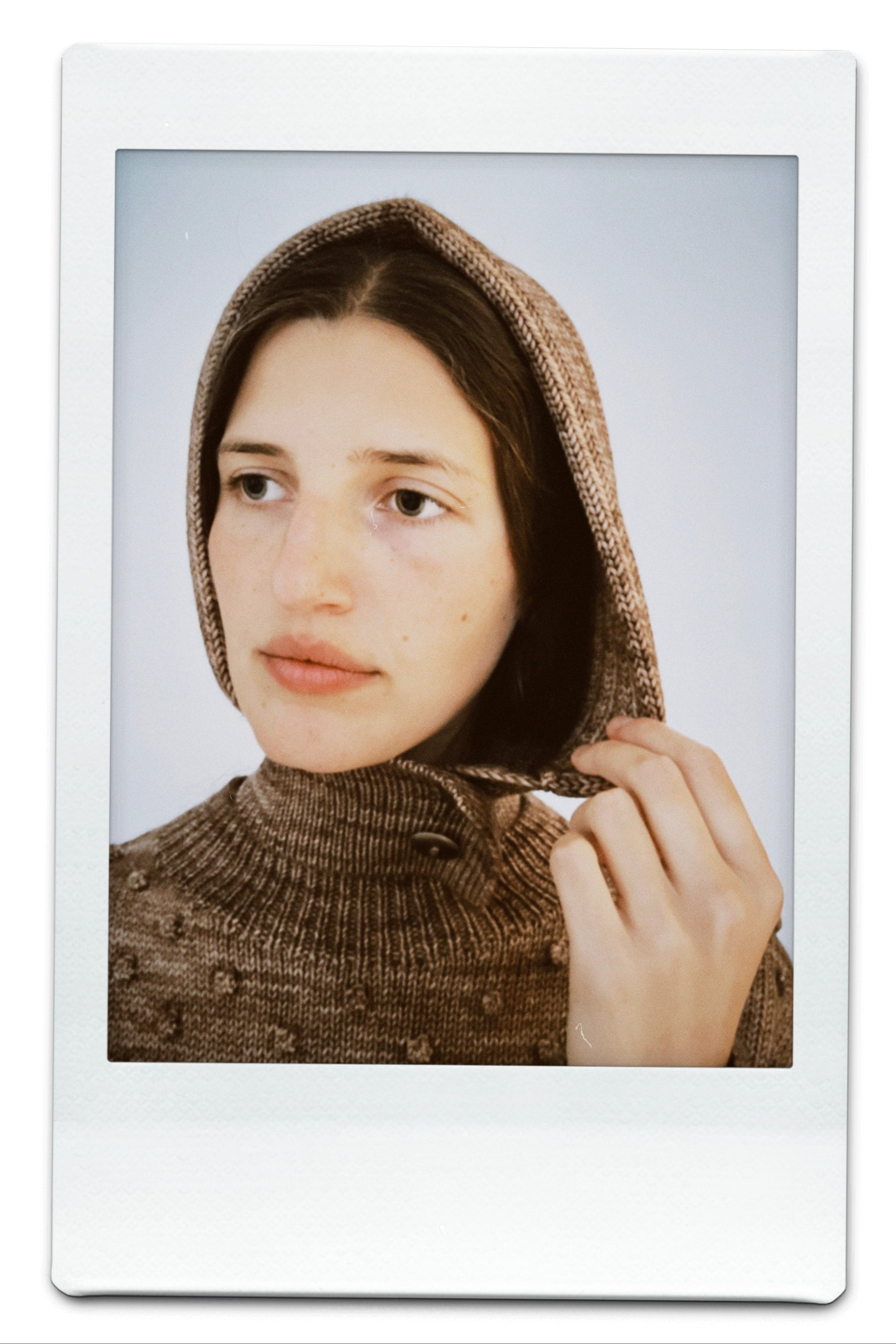 A polaroid photo of a person wearing the Misha & Puff hoodie.
