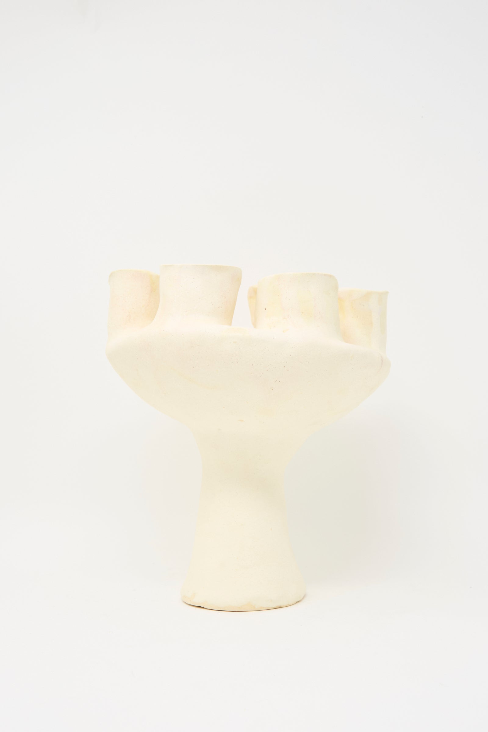 The MONDAYS Glazed Porcelain Tulipiere in White features an abstract design with a wide base and multiple cylindrical openings, showcased against a plain white background.