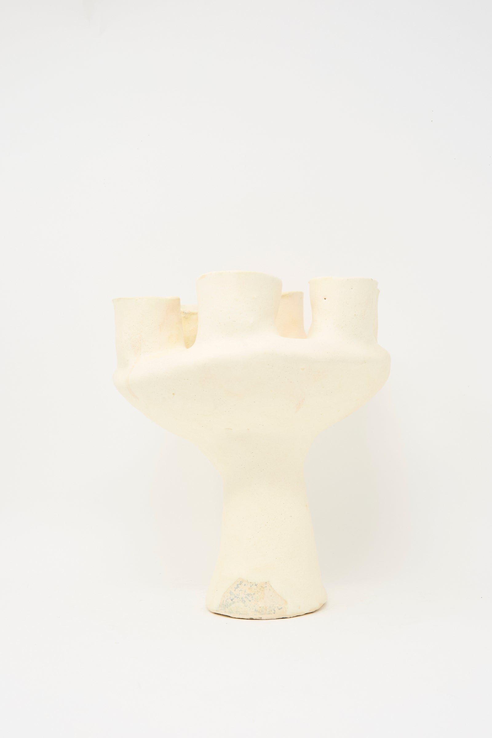 The MONDAYS Glazed Porcelain Tulipiere in White features four cylindrical openings and an uneven, textured surface, shown against a plain white background.