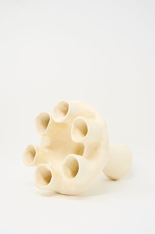 The MONDAYS Glazed Porcelain Tulipiere in White features a rounded base and seven tubular openings arranged in a circle at the top, shown against a plain white background.