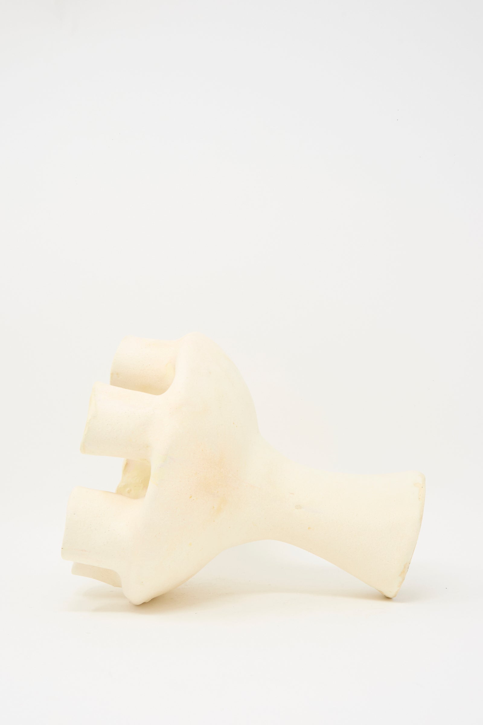 The MONDAYS Glazed Porcelain Tulipiere in White features an abstract, hand-like design with four thick fingers and a short cylindrical base, shown against a plain white background.