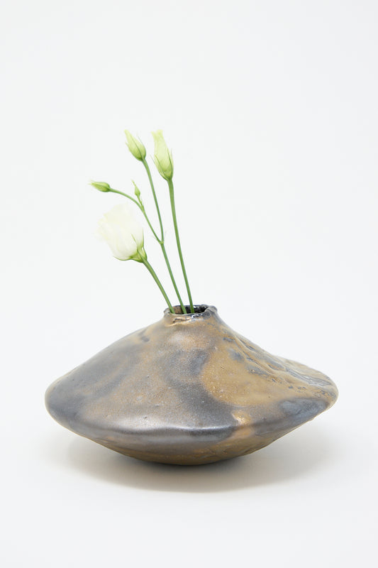 A MONDAYS Ikebana Vase in Bronze with a flower in Brooklyn.