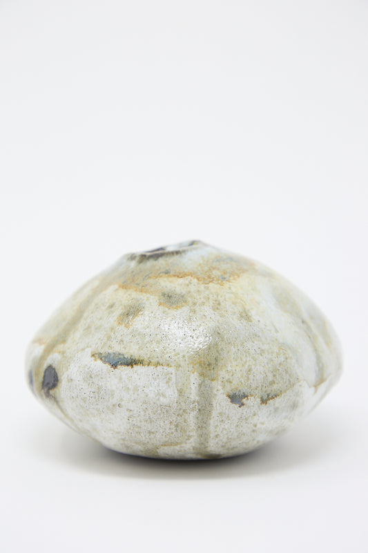 A Mini Moon Bud Vase in Glazed Stoneware sitting on top of a white surface by MONDAYS.