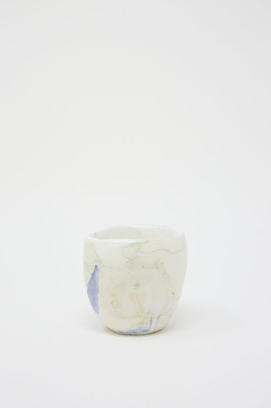 A MONDAYS Porcelain Tumbler in Blue and Green resting on a white surface in Brooklyn.