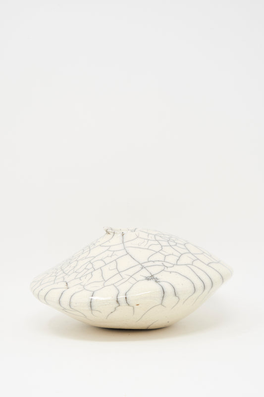 The MONDAYS Raku Ikebana Vase Large is a white, round, flat stoneware vase with a small opening and crackled glaze, crafted using Raku firing. Not water-safe and shown on a plain white background.