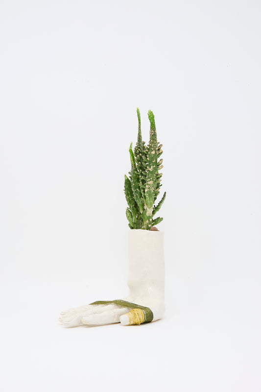 The Monty J Ceramic Hand Sculpture with Green Thread holds a tall green cactus, displayed against a plain white background.
