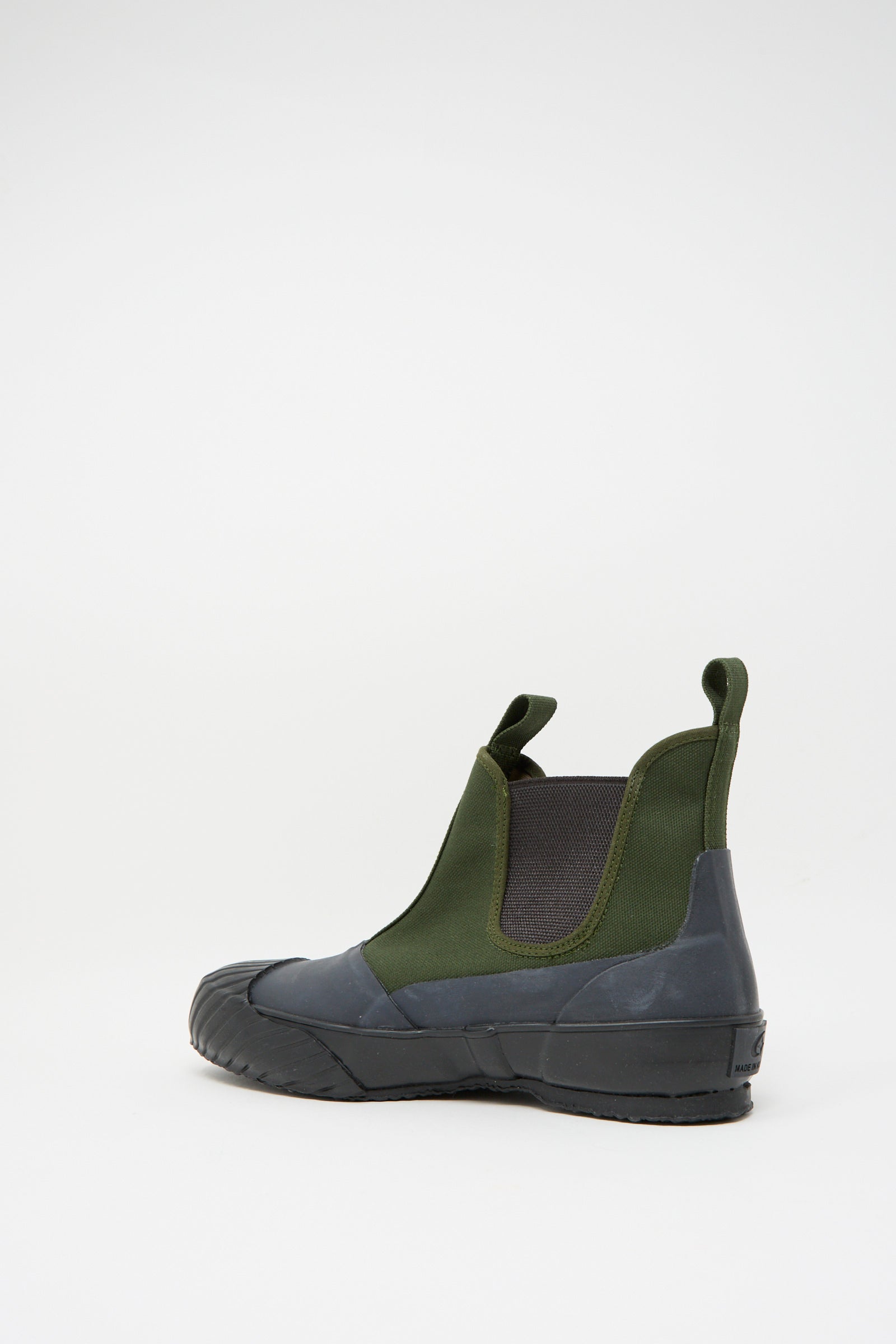 The Moonstar Alweather Sidegoa in Khaki is a green rubber boot with a black sole and pull tabs, displayed against a plain white background, showcasing craftsmanship reminiscent of Made in Japan design.