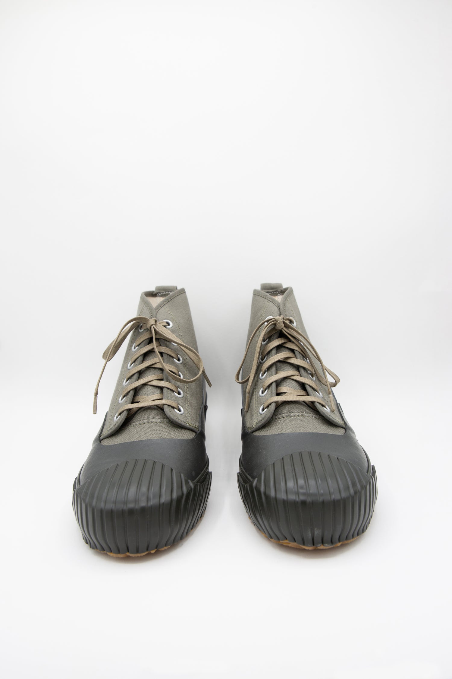 A pair of Moonstar Alweather Sneakers in Olive with a rubber sole on a white background. Front view.