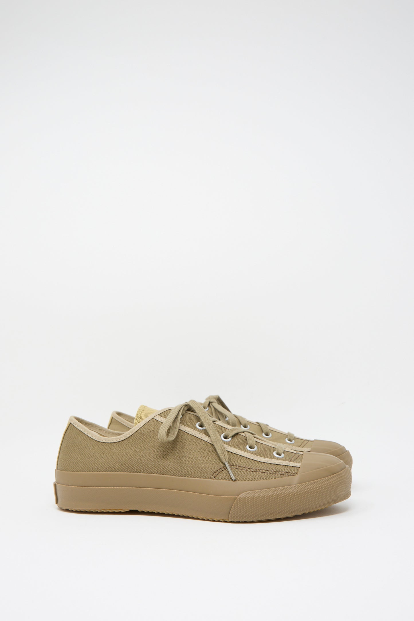 The Moonstar Gym Classic in Beige Multi shoes showcase a low-top design with durable canvas, rubber soles, and laces, viewed from the side on a plain white background.